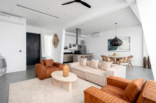 a living room with a couch and chairs and a table at Golden Lotus Villas in Amphoe Koksamui