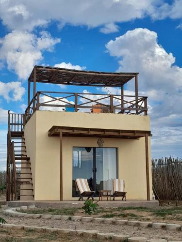 a small house with a balcony on top of it at Tres Velas Surf in Celestino Gasca