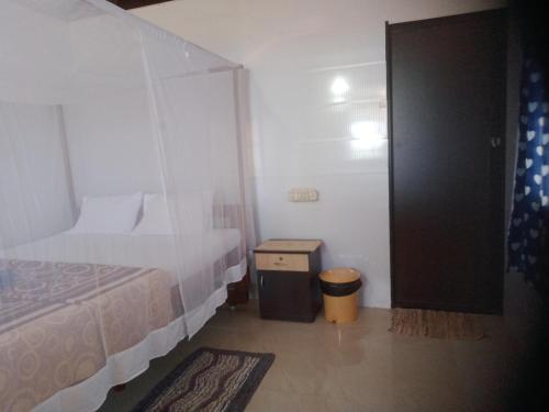 a bedroom with a bed and a door to a room at Agonda Dream View in Agonda