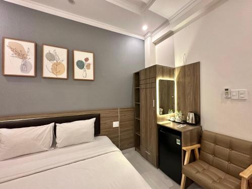 a bedroom with a bed and a sink and a mirror at Amora Hotel & Apartment in Vung Tau