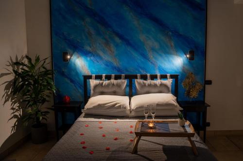 a bedroom with a bed with a blue wall at B&B La Sorgente in Brindisi