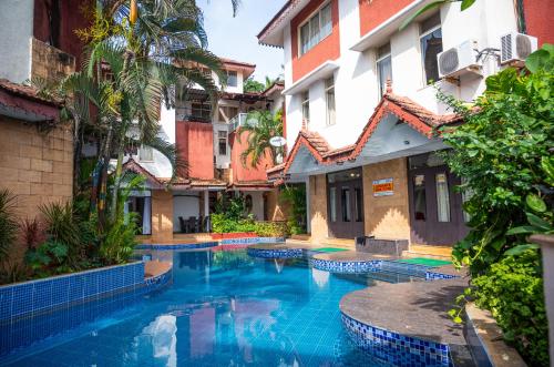 a swimming pool in a courtyard of a building at Ronne's Candy Floss Blue Lagoon villa in Guirim