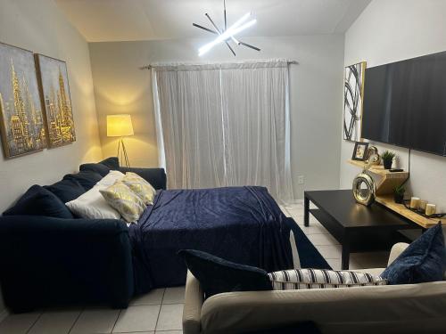 a living room with a bed and a couch at Traveler Stay PLUS in Eagle Pass