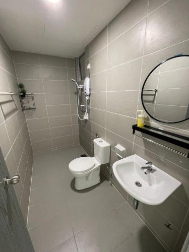 a bathroom with a toilet and a sink and a mirror at Rumah Puteh Homestay in Ipoh