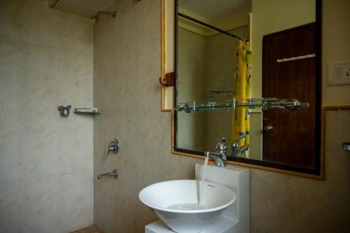 a bathroom with a sink and a mirror at Ronne's Candy Floss Blue Lagoon villa in Guirim