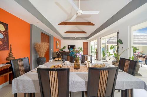 a dining room with a table and chairs at Stunning 5 bedrooms Villa with Panoramic Sea View in Por Bay