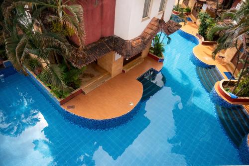 an overhead view of a large swimming pool at Ronne's Candy Floss Blue Lagoon villa in Guirim