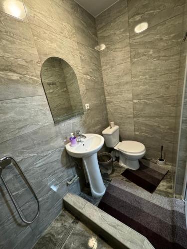 a bathroom with a sink and a toilet at Мотель Ріта in Berehove