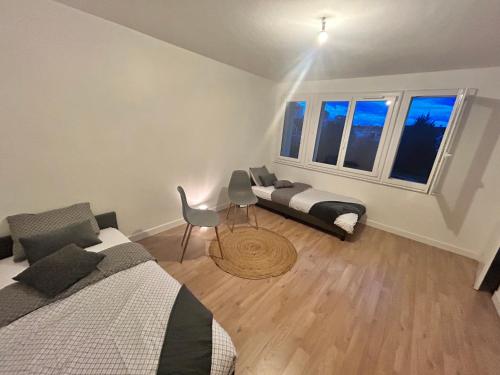 - une chambre avec deux lits, un canapé et deux fenêtres dans l'établissement Annecy Lakeside Studio, à Annecy