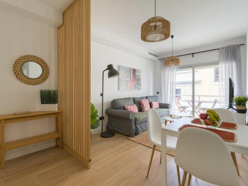 a living room with a couch and a table at Pascal Home By CanariasGetaway in Las Palmas de Gran Canaria