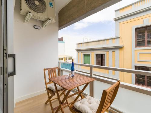 a balcony with a table and two chairs and a window at Pascal Home By CanariasGetaway in Las Palmas de Gran Canaria