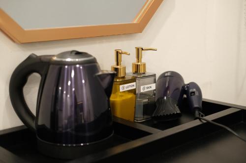 a black coffee pot sitting on a black counter top at Busan Seomyeon Broa Hotel in Busan
