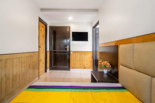 a room with a large colorful rug on the floor at Itsy Hotels Avantika With Forest View in Shimla