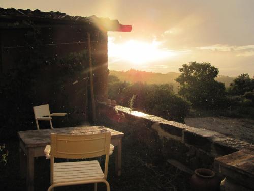 a table and chair on a patio with the sunset at SommaVilla B&B in Vicchio