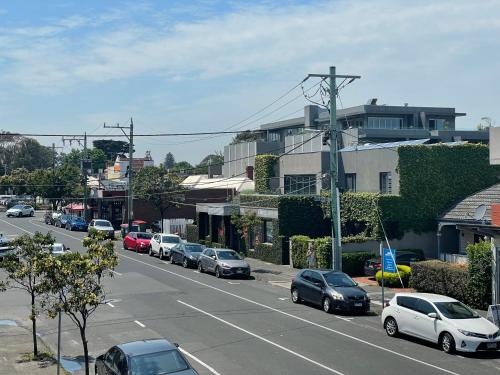 a street with cars parked on the side of a road at Beachside flat with free parking in Melbourne