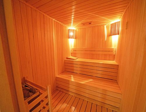 a wooden sauna with a wooden floor and lights in it at Siu Collection - Ultra All Inclusive in Beldibi