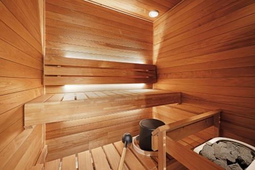a wooden sauna with a trash can in it at Original Sokos Hotel Seurahuone Savonlinna in Savonlinna