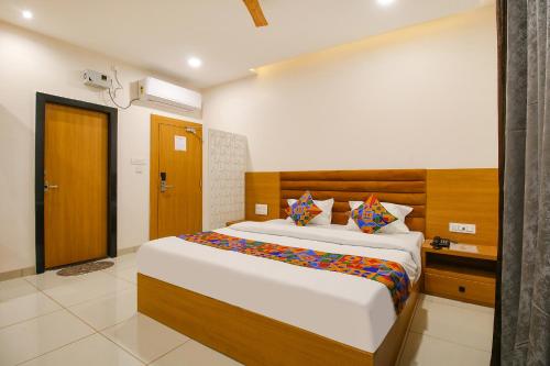 a bedroom with a large bed in a room at FabHotel The Gravity Inn in Indore