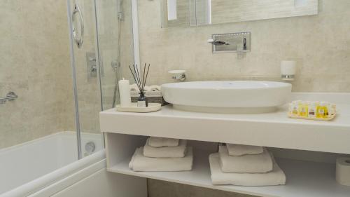 y baño blanco con lavabo y ducha. en DiliMah Premium Luxury, en Samarkand