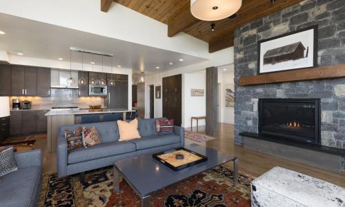 a living room with a couch and a fireplace at Silvertip Cabin 16 Alpine Bend in Big Sky