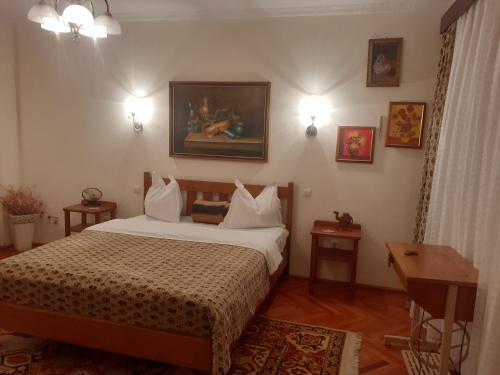 a bedroom with a bed and a table and lights at Casa Insorita in Sinaia