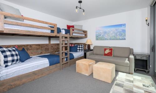 a bedroom with two bunk beds and a couch at Lake Cabin 19 Lakewood in Big Sky