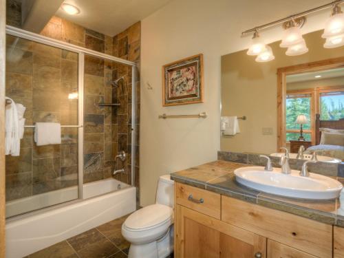 a bathroom with a sink and a shower and a toilet at Black Eagle 10 in Big Sky