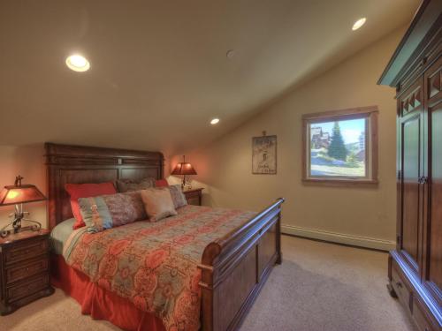 a bedroom with a large bed and a window at Black Eagle 32 in Big Sky