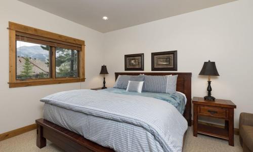 a bedroom with a bed and a window at Alpenglow 22B in Big Sky
