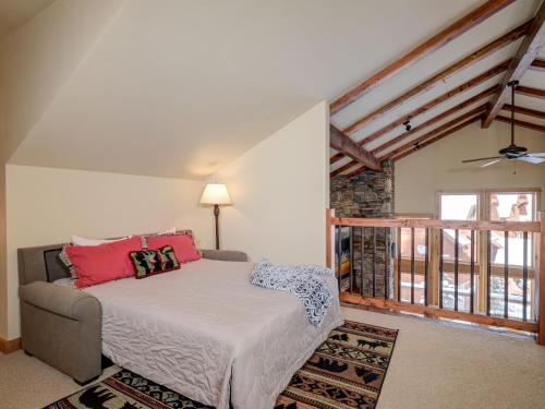 a bedroom with a bed and a large window at Black Eagle 31 in Big Sky