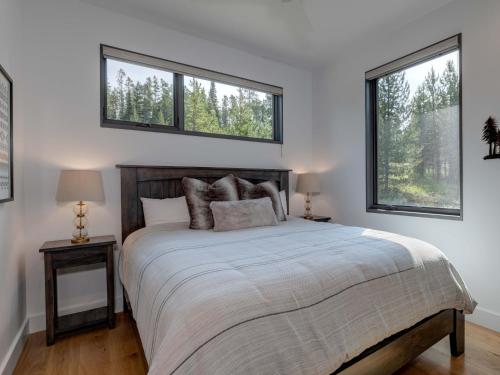 sypialnia z dużym łóżkiem i 2 oknami w obiekcie Lake Cabin 26 Lakewood w mieście Big Sky