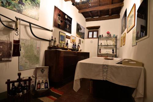 a room with a table with wine bottles on it at Castellinuzza in Greve in Chianti