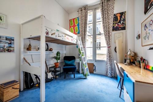 a bedroom with a bunk bed and a desk at Veeve - Square du Temple Comfort in Paris