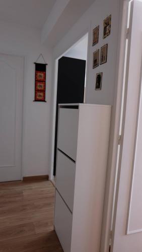 a white refrigerator in a room with a hallway at Chambre spacieuse et lumineuse chez l'habitant in Nice