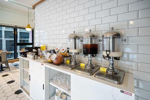 a kitchen with a counter with some food on it at CHECK inn Taipei Songjiang in Taipei