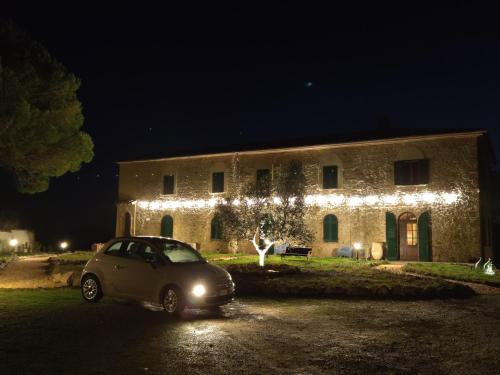 a car parked in front of a building with christmas lights at Podere Campiano in Volterra