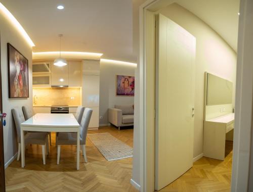 a dining room and living room with a table and chairs at Center Tirana Liv apartment in Tirana
