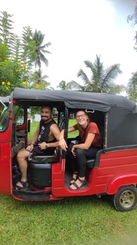 three men sitting in the back of a small van at Rivendell Twisted Tree in Kurunegala