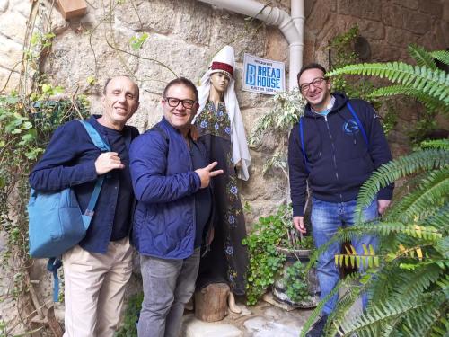a group of people standing in front of a statue at BREAD HOUSE in Bethlehem
