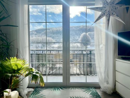 a room with a large window with a view at Apartament Dobre Miejsce in Ustrzyki Dolne