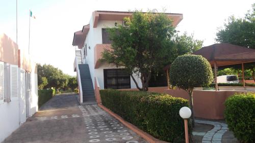 a house with a walkway in front of a building at Kyriakos Studios in Afantou