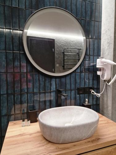 a bathroom with a sink and a mirror at Котедж Gudz in Yaremche