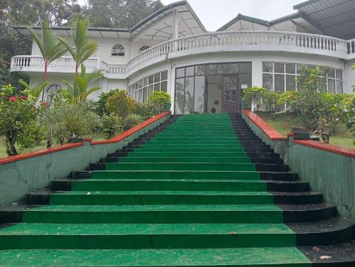 a house with a staircase in front of a house at ROYAL MOUNT HOTEL in Gampola