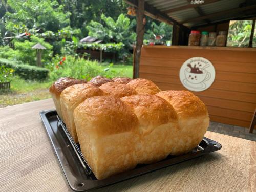 a loaf of bread sitting on a plate on a table at kohkoodfarmstay in Ban Ao Yai