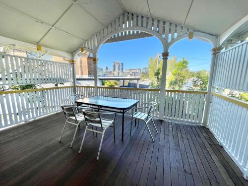 a porch with a table and chairs on a balcony at Minto Accommodation Brisbane in Brisbane