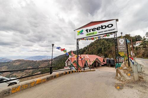 a sign for a treeoco gas station on the side of a road at Treebo Trend Snow View Resort Kufri With Mountain View in Shimla