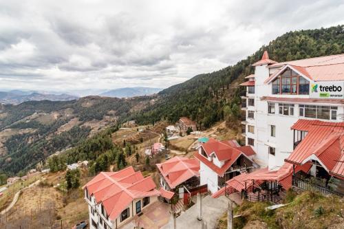 an aerial view of a hotel in the mountains at Treebo Trend Snow View Resort in Shimla