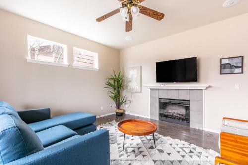 a living room with a blue couch and a fireplace at Issaquah 4br w workspace backyard nr dining SEA-676 in Issaquah