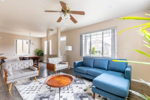 a living room with blue furniture and a ceiling fan at Issaquah 4br w workspace backyard nr dining SEA-676 in Issaquah
