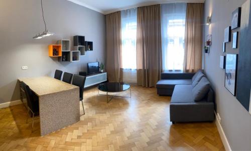 a living room with a couch and a table at Holec Apartments in Prague
